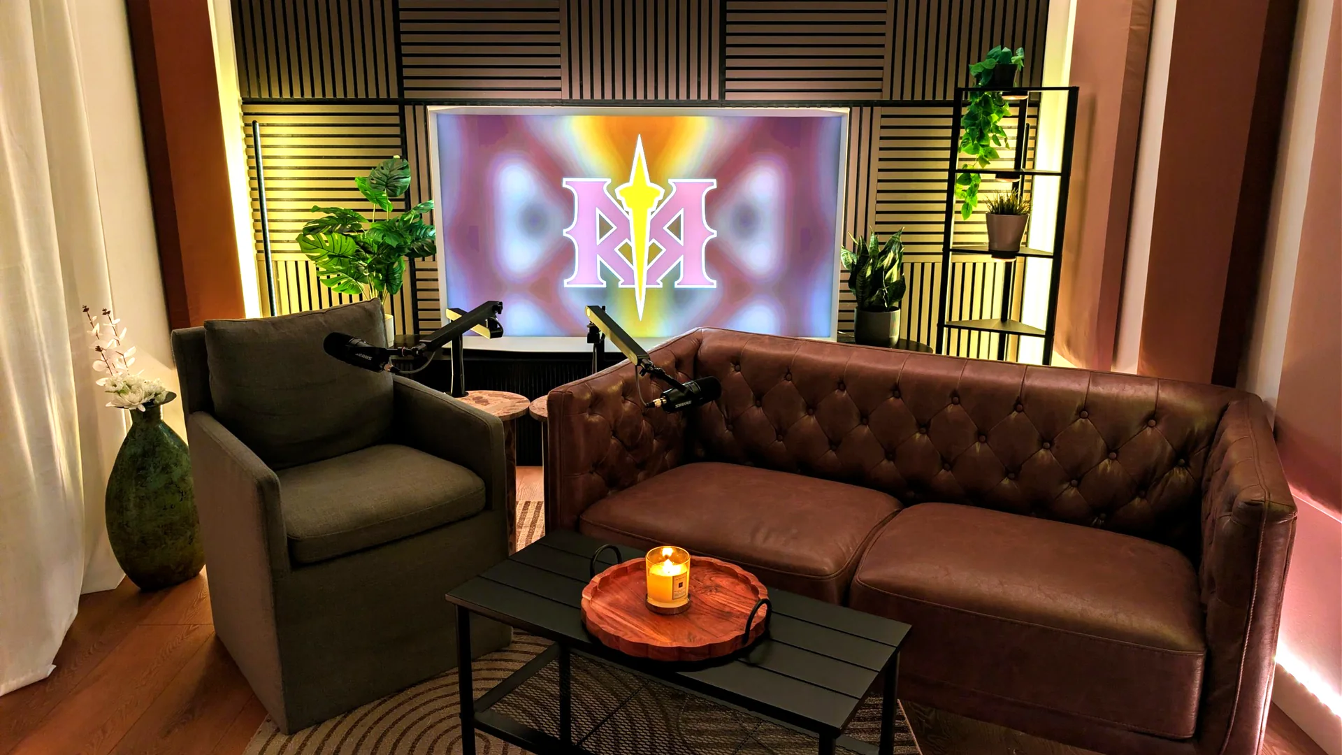 The Red Mile Records podcast set in Calgary with leather couch, Shure microphones and the RMR logo on the studio screen
